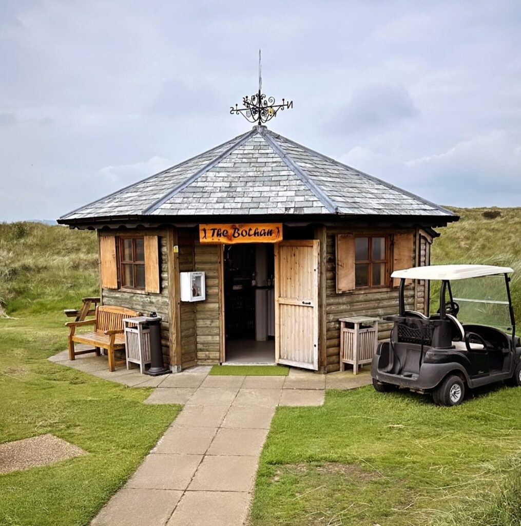 Small wooden hut with a sign reading 